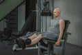 Male athlete performs leg extension on the simulator