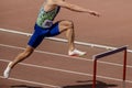 male athlete runner attack hurdle 400 meters running race