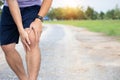 Male athlete runner knee injury and pain after jogging. Athlete man runner touching knee in painful Royalty Free Stock Photo