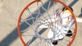 Male athlete shooting ball through basket, professional basketball player Royalty Free Stock Photo