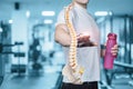 Male athlete shows a model of the spine