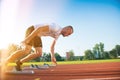 Male athlete on starting position at athletics running track. Royalty Free Stock Photo