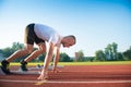 Male athlete on starting position at athletics running track. Royalty Free Stock Photo