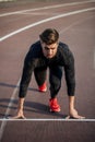 Athlete on starting position at running track. Runner practicing run in stadium racetrack Royalty Free Stock Photo