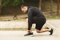 Male athlete tying running shoes lases getting ready for run Royalty Free Stock Photo