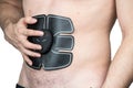 Male athlete wearing a electric ab muscle stimulator doing abs exercise Royalty Free Stock Photo