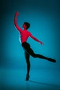 The male athletic ballet dancer performing dance on blue background. Studio shot. Ballet concept. Fit young man Royalty Free Stock Photo