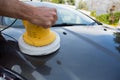 Auto service staff cleaning a car bonnet with rotating wash brush Royalty Free Stock Photo