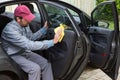 Auto service staff cleaning car door Royalty Free Stock Photo