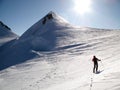 Male back country skier on a ski toru on his way to a high alpine summit in the Monte Rosa mountains on a huge glacier