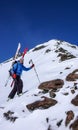 Male backcountry skier going up a snow slope in the backcountry of the Swiss Alps on a ski tour in winter