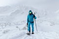 Male backcountry skier hiking to the summit of a snowy peak in the Low Tatras in Slovakia.