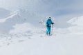 Male backcountry skier hiking to the summit of a snowy peak in the Low Tatras in Slovakia.