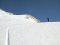 Male back country skier on a ski tour on his way to a high alpine summit in the Monte Rosa mountains on a huge glacier