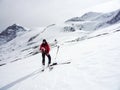 Male backcountry skier studies a map on a high alpine glacier in the Austrian Alps