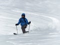 Male backcountry skier telemark skiing in the Alps in fresh powder