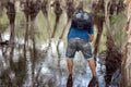 Male backpacker through tropical jungle stream deep in the rain forest exploring the nature Royalty Free Stock Photo