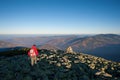 Male backpaker walking on the rocky top of the mountain