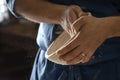 Male baker lightly flouring proofing basket for home made sourdough bread.