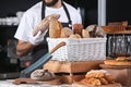 Male bakery with fresh bread in shop