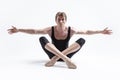 Male Ballerino Dancer Sitting While Practising Legs and Arms Stretching Exercices In Black Sportive Tights in Studio