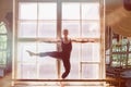 Male ballet dancer is dancing in front of a window Royalty Free Stock Photo