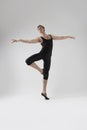 Male Ballet Dancer Flexible Athletic Man Posing in Black Tights in Ballanced Dance Pose With Hands Lifted and Leg Crossed