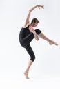 Male Ballet Dancer Man in Black Dance Suit Tights Posing in Ballanced Dance Pose While Stretching His Arm and Leg Muscles in