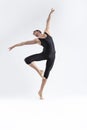 male Ballet Dancer Young Athletic Man in Black Suit Posing in Ballanced Stretching Dance Pose Studio On White Royalty Free Stock Photo