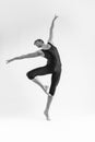 male Ballet Dancer Young Athletic Man in Black Suit Posing in Ballanced Stretching Dance Pose Studio On White