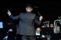 Male band conductor conducting his concert band