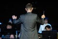 Male band conductor conducting his concert band