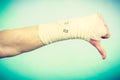 Male bandaged hand with thumb down sign. Royalty Free Stock Photo