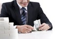 Male banker is counting banknotes on white background