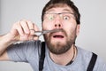 Male barber cuts his own mustache, looking at the camera like the mirror. stylish professional hairdresser expresses Royalty Free Stock Photo