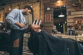 Male barber cutting hair of customer in barber Royalty Free Stock Photo