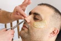 Male barber cutting hairs in the nose by scissors at the adult man in Turkey