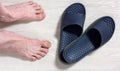 Male Bare Feet and a Pair of Flip Flops Royalty Free Stock Photo