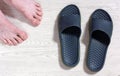 Male Bare Feet And A Pair Of Flip Flops