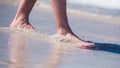 Male Bare Feet In A Warm Sand, Man Taking A Walk On A Sunny Beach With Turquoise Water