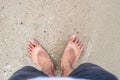 Male barefoot on the beach with suntanned shape of sandals