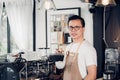 Male Barista cafe owner holding coffee cup in store counter bar Royalty Free Stock Photo