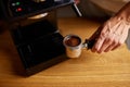 Male barista hand making espresso from ground coffee maker at modern cafe Royalty Free Stock Photo