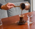 A male barista hand pouring fresh Turkish coffee Royalty Free Stock Photo