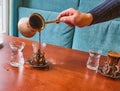 A male barista hand pouring fresh Turkish coffee Royalty Free Stock Photo