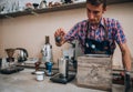 Male barista making cappuccino at counter in coffeeshop Royalty Free Stock Photo