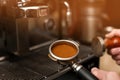 Male barista making espresso using professional coffee machine Royalty Free Stock Photo