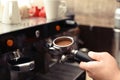 Male barista making espresso using professional coffee machine Royalty Free Stock Photo