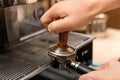 Male barista making espresso using professional coffee Royalty Free Stock Photo