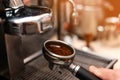Male barista making espresso using professional coffee machine Royalty Free Stock Photo